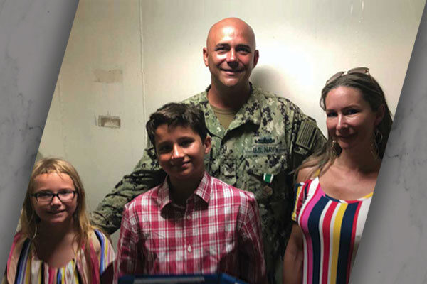 Danny Barker in his U.S. Navy uniform with his family